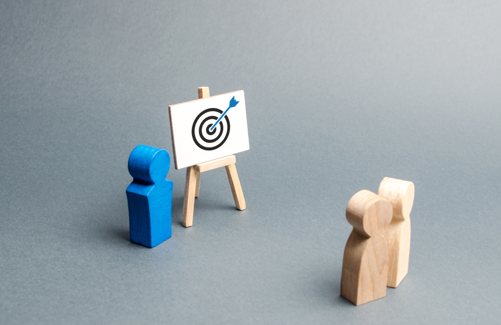 Bonecos de madeira representando uma apresentação de objetivo
